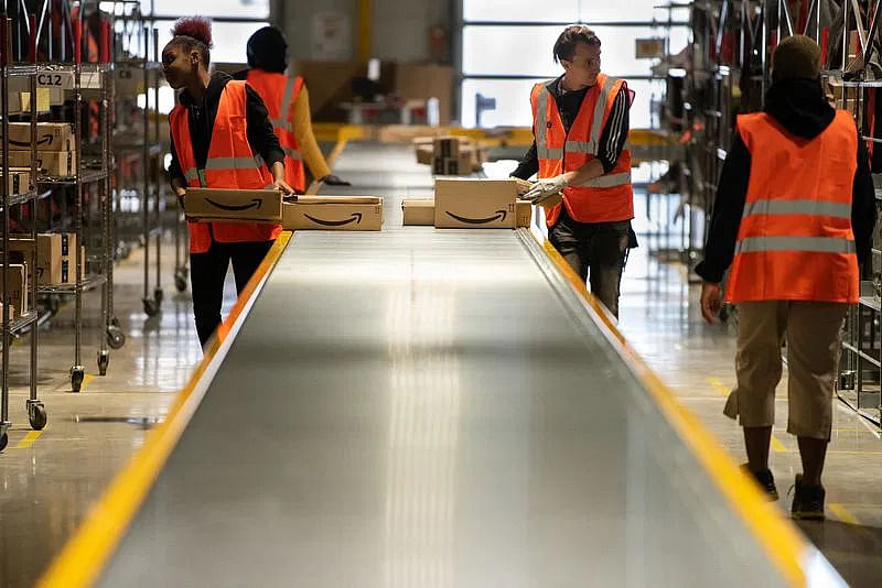 amazon's warehouse with employees sorting the products