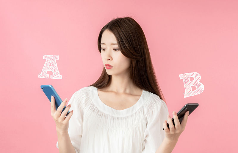 woman making a choice with two smartphones