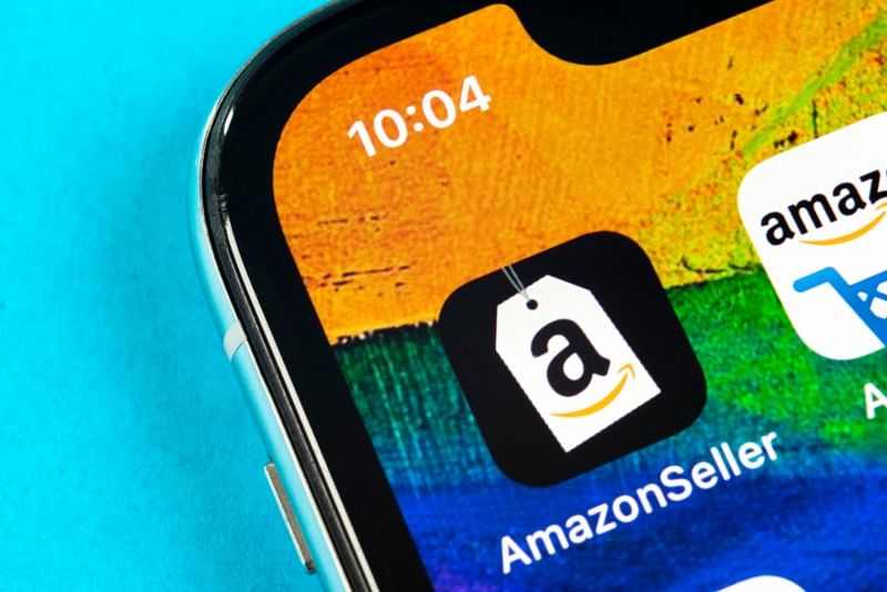 closeup shot of a phone screen showing the Amazon seller app against a colorful wallpaper