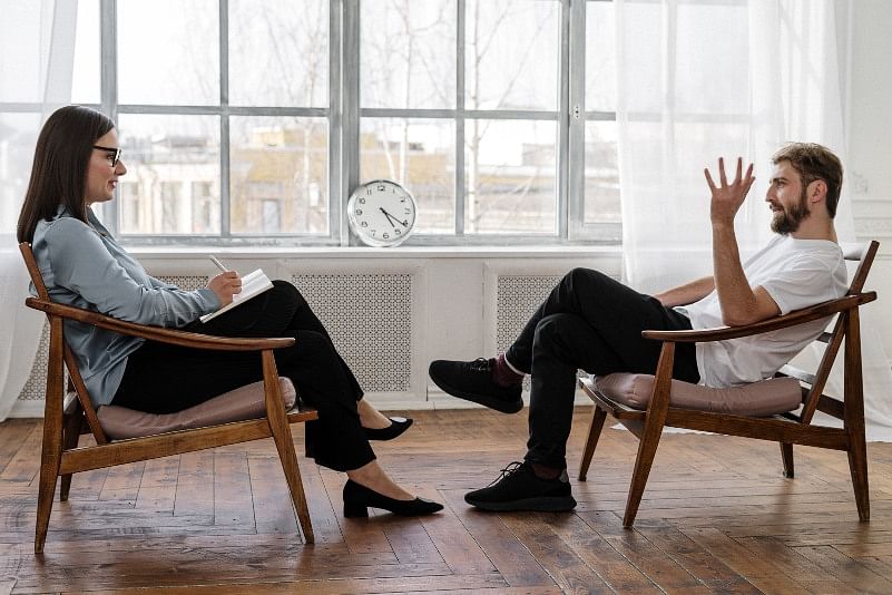 shot of two people sitting across each other while having a consultation